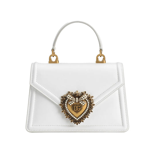 White handbag with a decorative heart emblem on a white background
